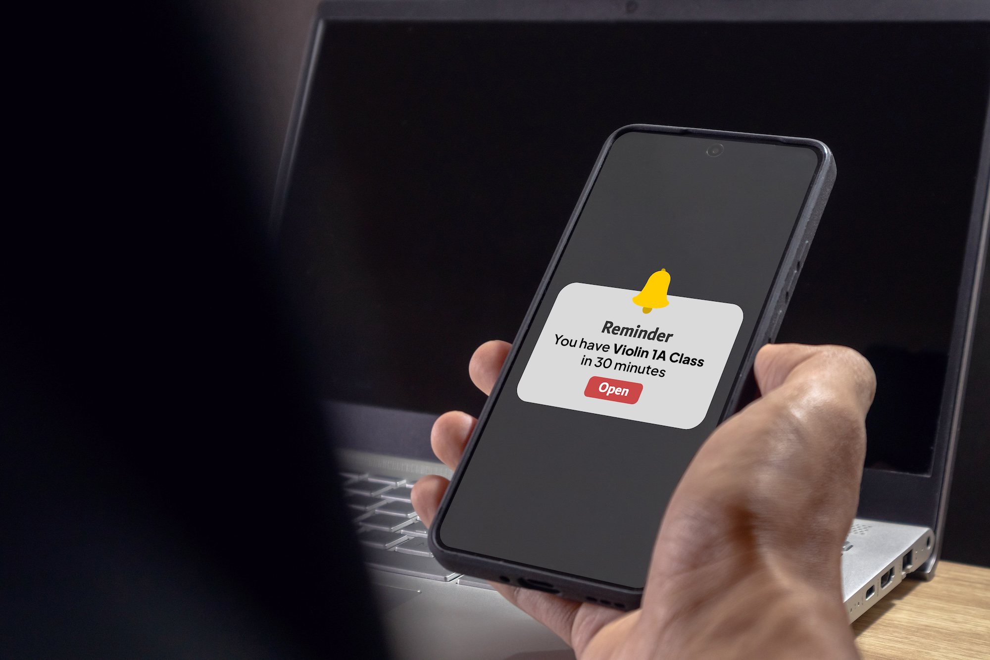 Smartphone displaying an automated class reminder notification for a violin lesson in 30 minutes.